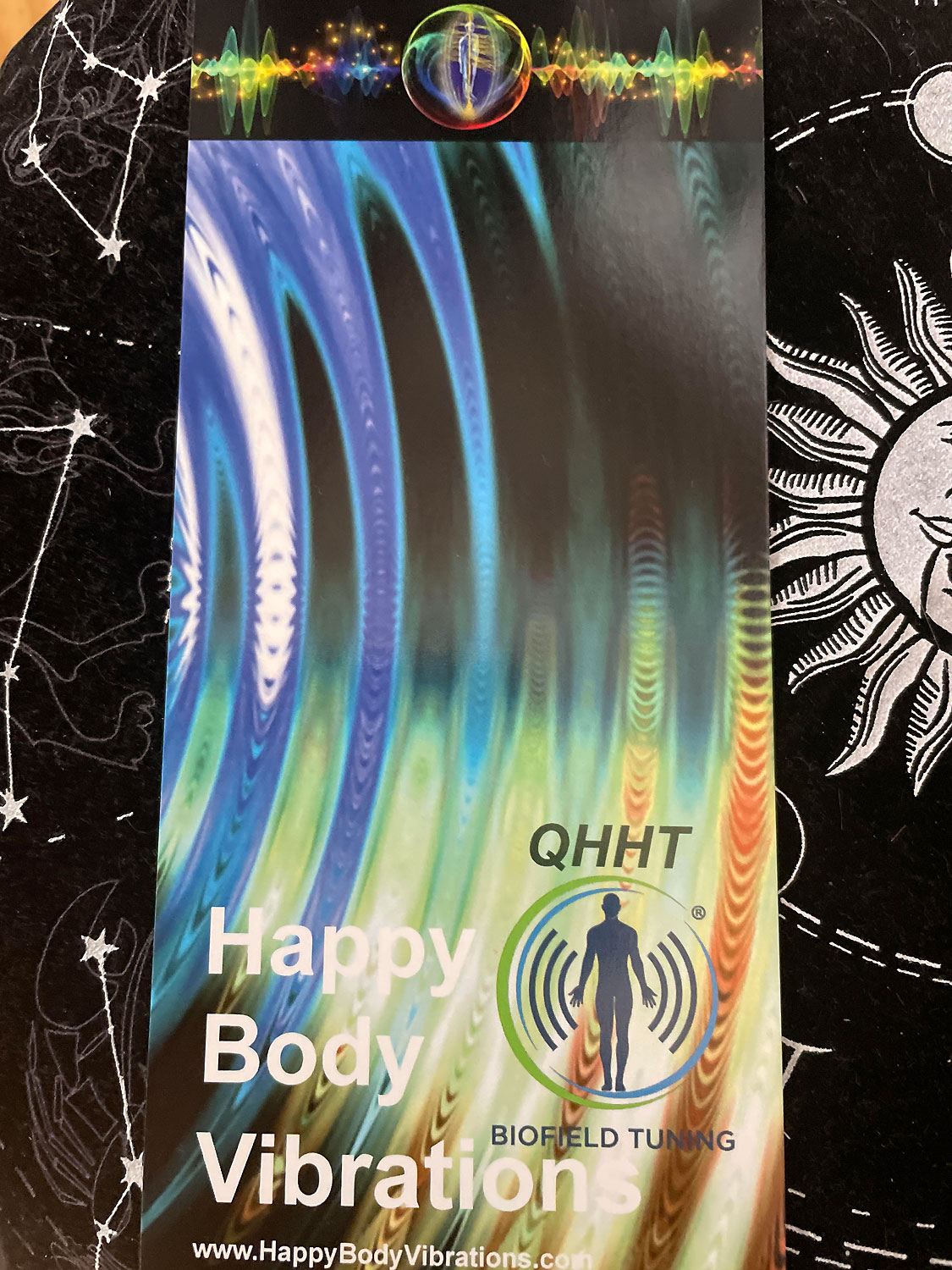 the front of a flyer with a water ripple with a logo that says QHHT Biofield Tuning and the text company name Happy Body Vibrations